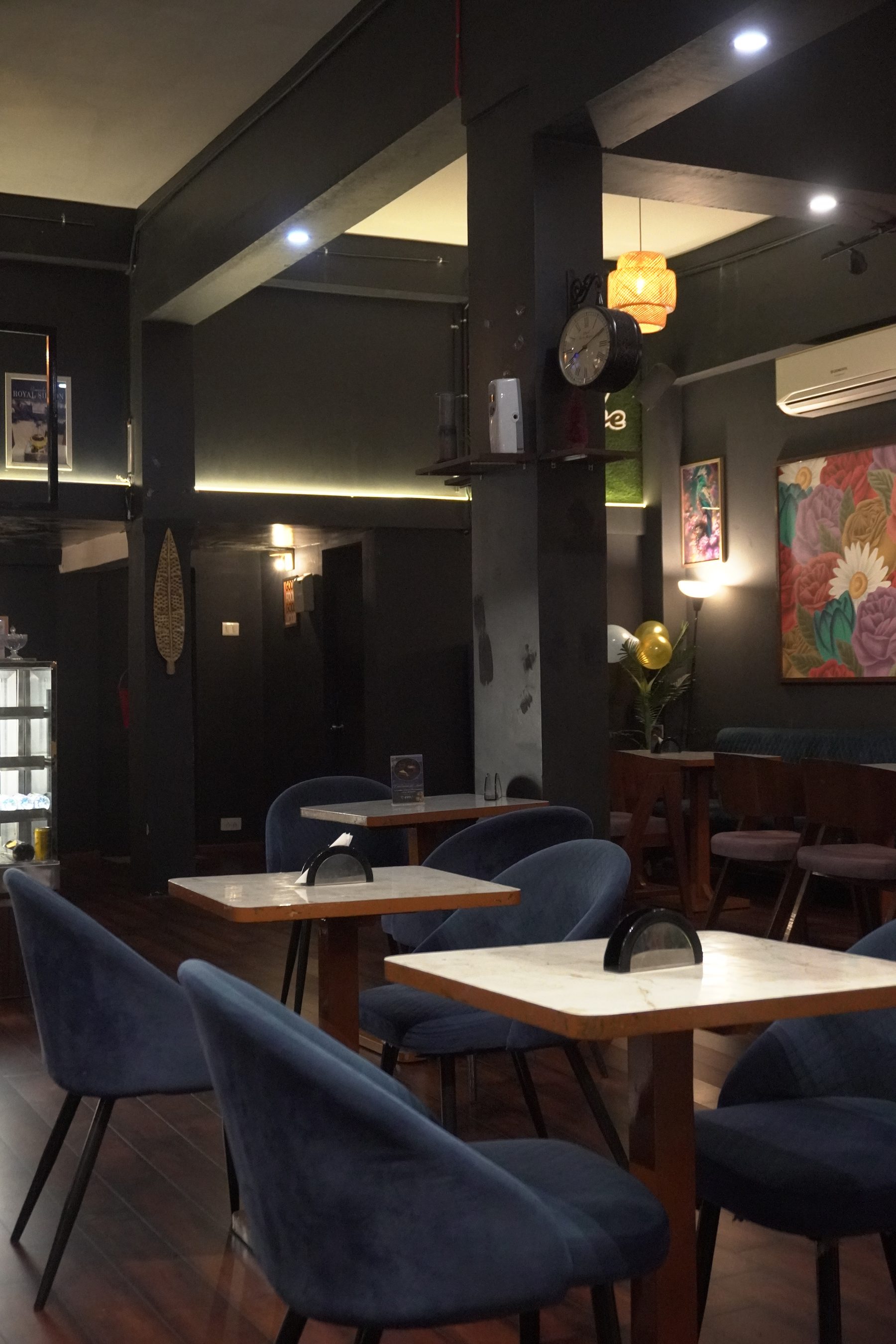 The navy lounge seating and floral mural wall at Panache